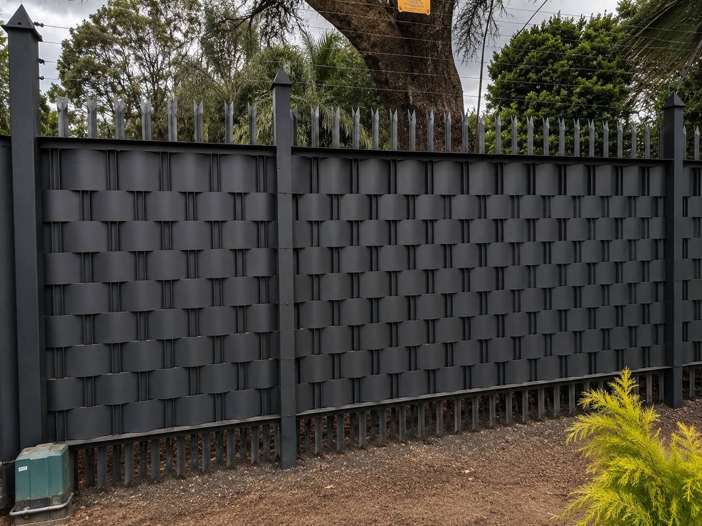 Woven palisade privacy fencing installed on a residential boundary